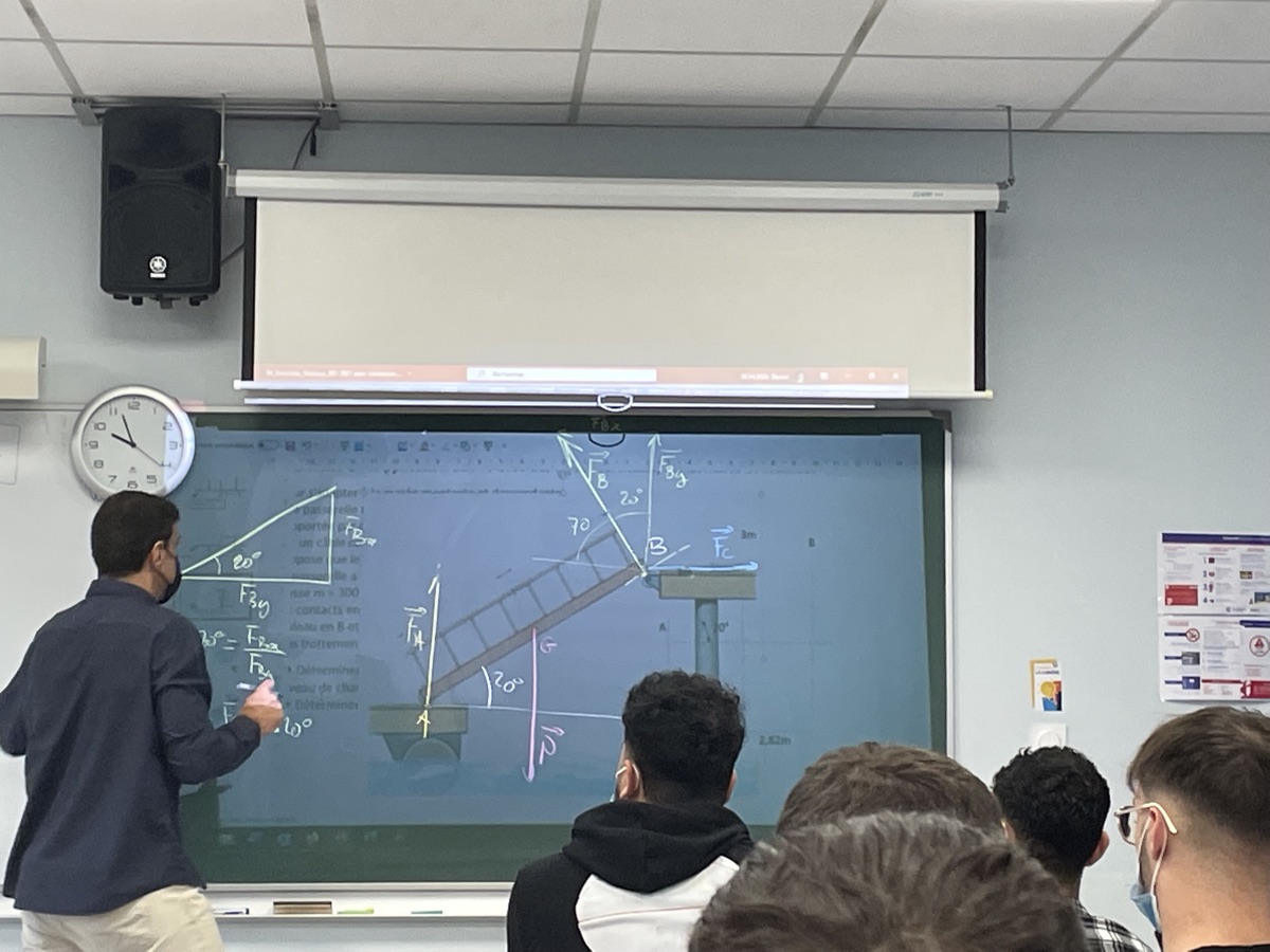 A professor explaining a structural-mechanics problem on a classroom whiteboard during my engineering studies